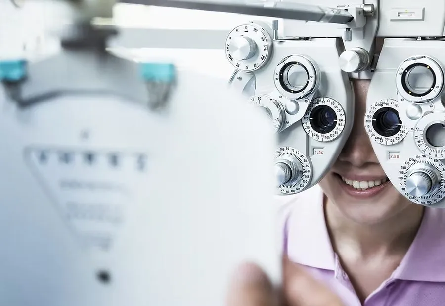 Patient undergoing a comprehensive eye exam with a phoropter
